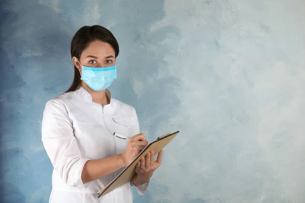 Médico Con Máscara Desechable Cara Sujetando Portapapeles Contra Fondo Azul — Foto de Stock
