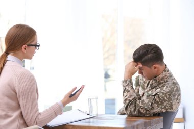 Psychotherapist working with military officer in office