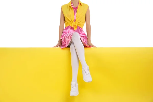 Woman wearing white tights sitting on color background, closeup — Stock Photo, Image