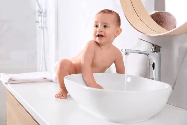 Cute little baby playing in bathroom at home — Stock Photo, Image