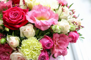 Beautiful fresh flowers on light background, closeup. Floral decor