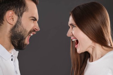 Couple quarreling on black background, closeup. Relationship problems