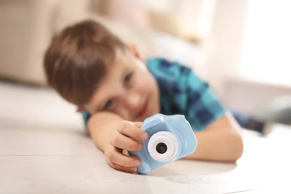Liten fotograf inomhus, fokus på hand med leksakskamera — Stockfoto