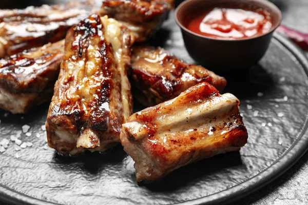 Delicious grilled ribs on board, closeup view — 스톡 사진