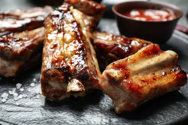 Delicious grilled ribs on board, closeup view — 스톡 사진