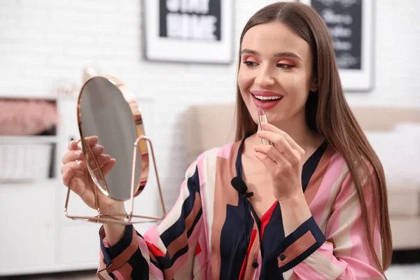 Female beauty blogger applying lipstick at home — Stock Photo, Image