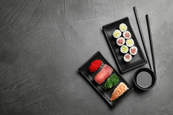 Conjunto Deliciosos Sushi Rolos Mesa Cinza Flat Lay Espaço Para — Fotografia de Stock