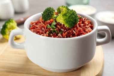 Tasty brown rice with broccoli on table, closeup