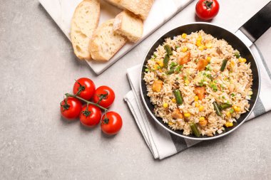 Açık gri masada tavuklu ve sebzeli leziz pirinç pilavı.