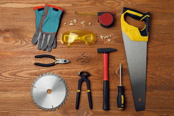 Different carpenter's tools on wooden background, flat lay — Stock Photo, Image