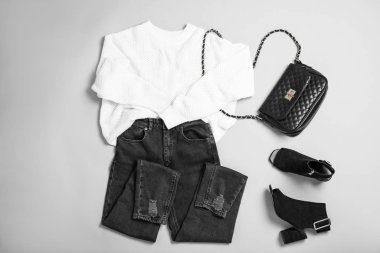 Stylish outfit with jeans on light grey background, flat lay