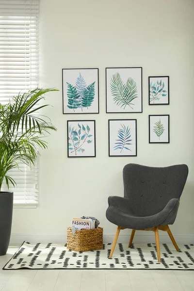 Beautiful paintings of tropical leaves on white wall in room int
