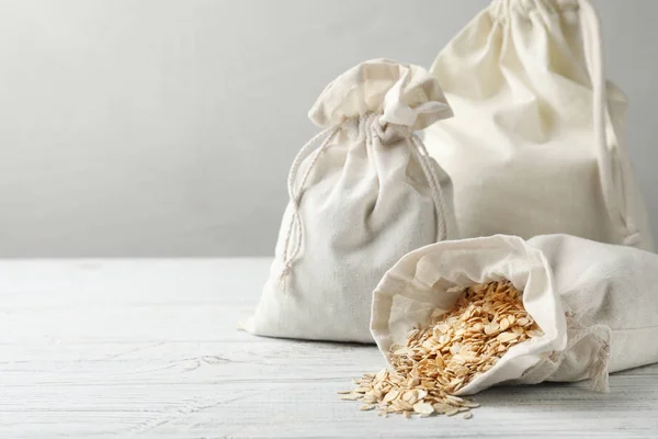 Cotton Eco Bags Oat Flakes White Wooden Table Space Text — 스톡 사진