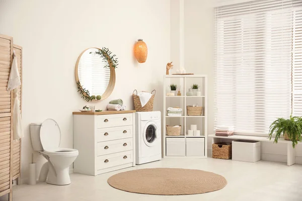 Interior of stylish bathroom with washing machine — 스톡 사진