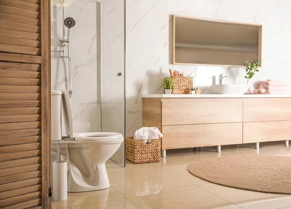 Elegante bagno moderno con armadio in legno vicino alla parete di marmo — Foto Stock