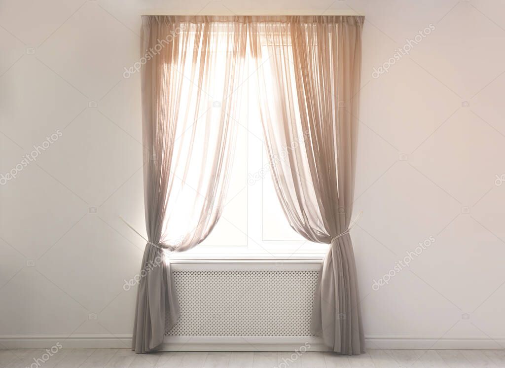 Window with beautiful curtains in empty room