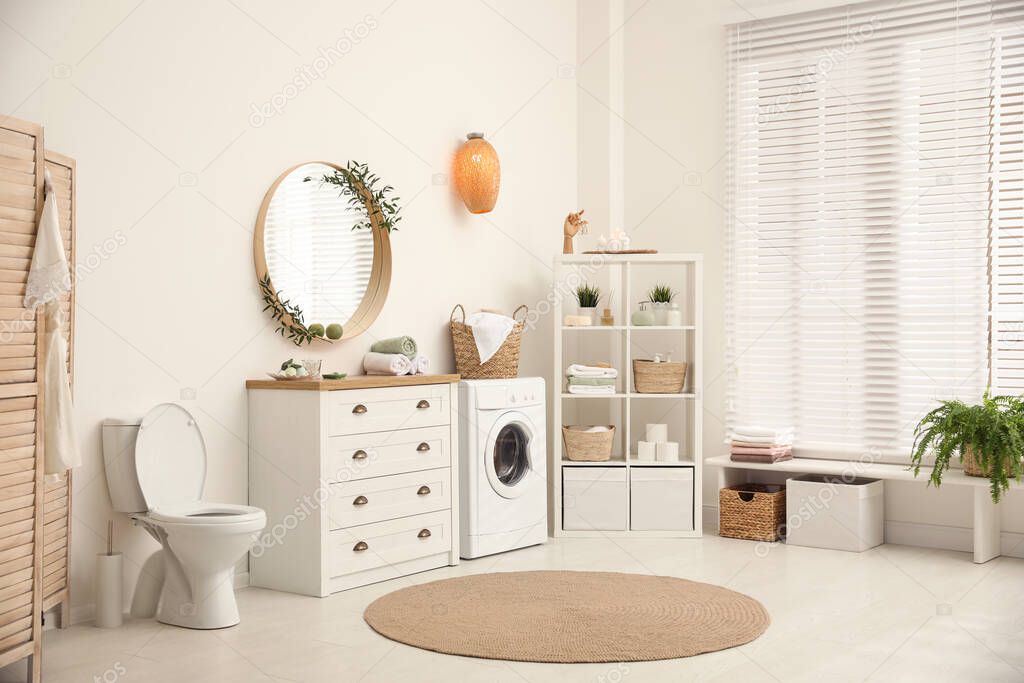 Interior of stylish bathroom with washing machine