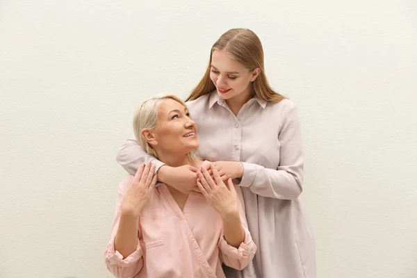 Mother and her adult daughter on white background — Stock Photo, Image