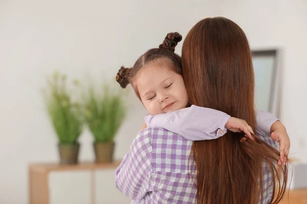 Una madre joven con una hija pequeña en casa. Espacio para texto — Foto de Stock