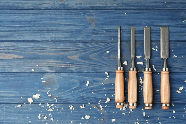 Modern Chisels Blue Wooden Background Flat Lay Space Text Carpenter — Stock Photo, Image