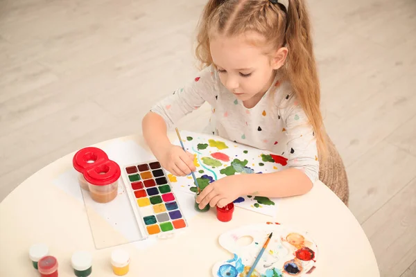 Cute little child painting at table in room — Stock Photo, Image