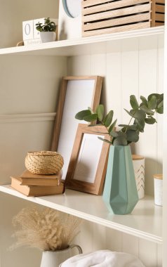 White shelving unit with different decorative elements