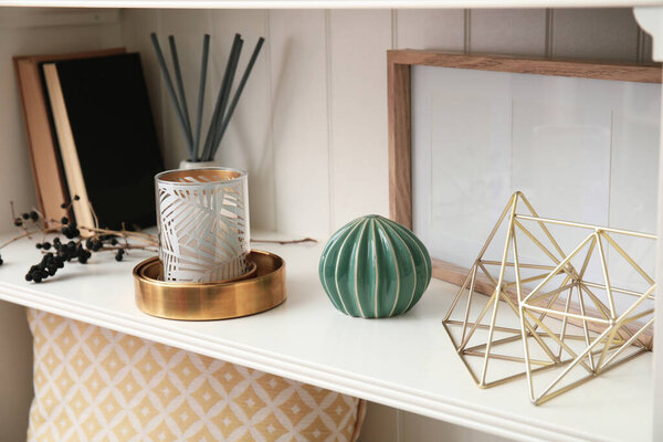 White shelving unit with books and different decorative stuff