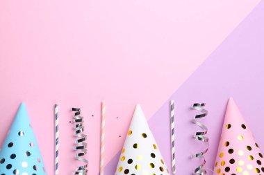 Flat lay composition with birthday caps on color background. Space for text