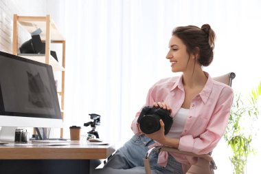 Ofiste çalışan kameralı profesyonel fotoğrafçı.