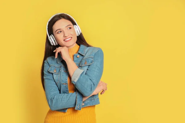 Young Woman Listening Audiobook Yellow Background Space Text — 스톡 사진
