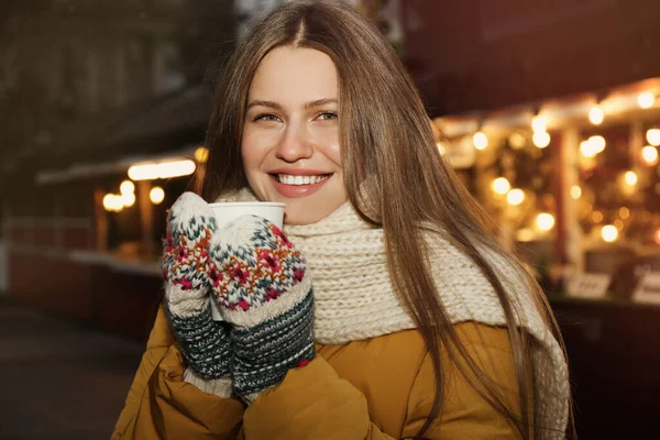 Щаслива жінка з глінтвейном на зимовому ярмарку — стокове фото
