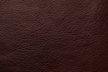 Arka plan olarak koyu kahverengi deri dokusu, yakın plan
