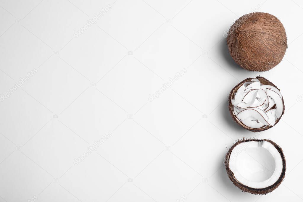 Composition with fresh coconut flakes on white background, top view