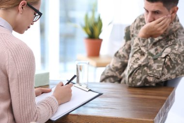 Psychotherapist working with military officer in office