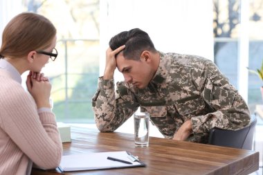 Psychotherapist working with military officer in office