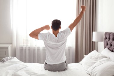 Evdeki adamın yatakta uyanması. Tembel sabah