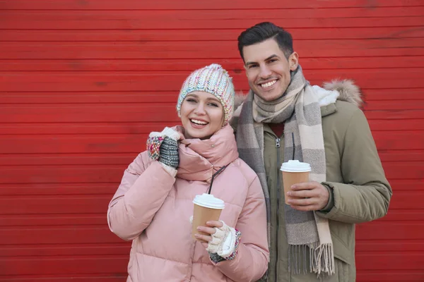 Happy Couple Warm Clothes Drinks Red Wooden Wall Outdoors Christmas — Stock Photo, Image