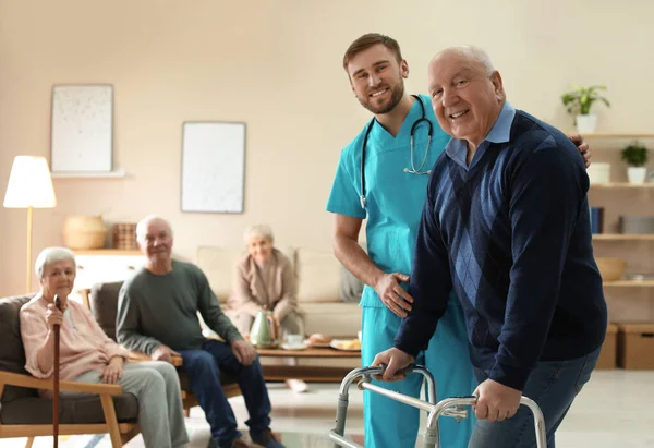 Care Worker Helping Elderly Man Walker Geriatric Hospice — 스톡 사진