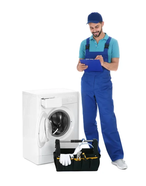 Repairman with clipboard and toolbox near washing machine on whi — 스톡 사진