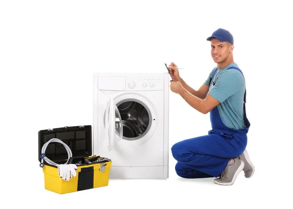 Repairman with clipboard and toolbox near washing machine on whi — 스톡 사진