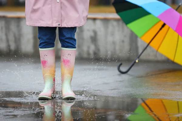 Woman in rubber boots walking outdoors on rainy day, closeup — ストック写真