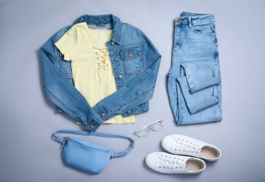 Stylish outfit with jeans on light grey background, flat lay