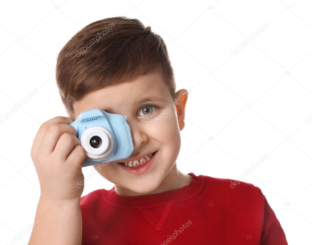 Little photographer taking picture with toy camera on white back