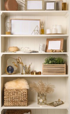 White shelving unit with different decorative elements