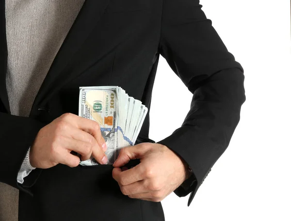 男人把贿赂的钱放在白色背景的口袋里，特写镜头 — 图库照片