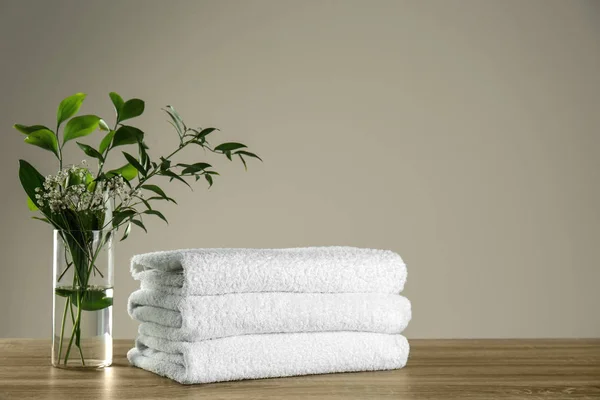Clean Bath Towels Vase Green Plants Wooden Table Space Text — Stock Photo, Image