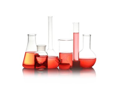 Different laboratory glassware with red liquid isolated on white