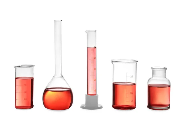 Different laboratory glassware with red liquid isolated on white — 图库照片