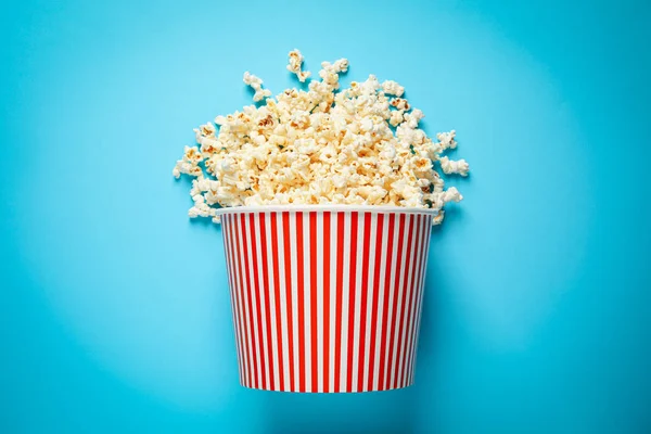 Umgekippter Papiereimer Mit Leckerem Popcorn Auf Hellblauem Hintergrund Ansicht Von — Stockfoto