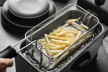 Sıcak yağda patates kızartması pişiriyorum.
